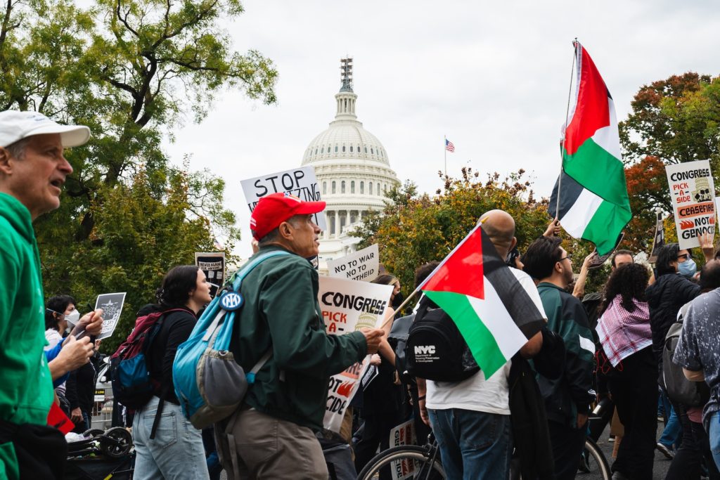 a group of people holding flags and signs