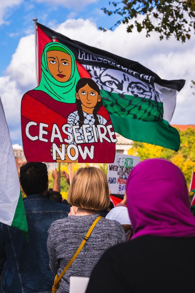 a group of people holding flags and signs